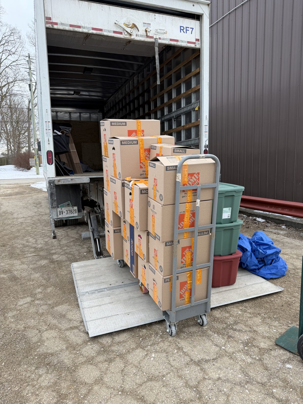 Boxes stacked on a moving cart at the truck ramp, ready to load