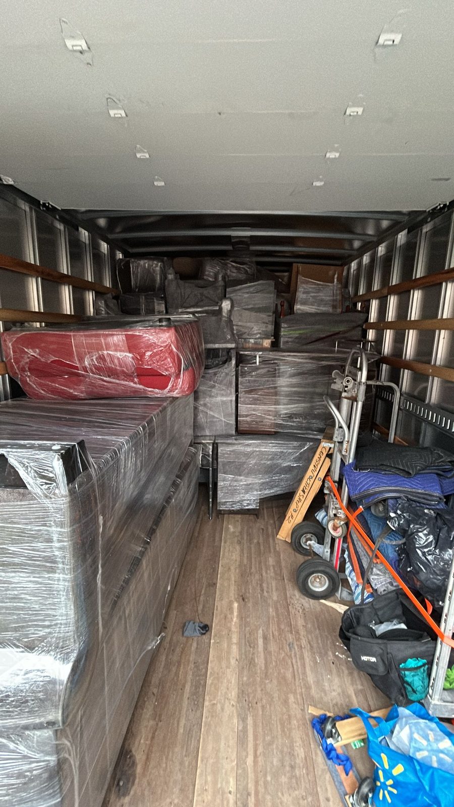 A Homeboy Movers truck packed tight with shrink-wrapped furniture and boxes
