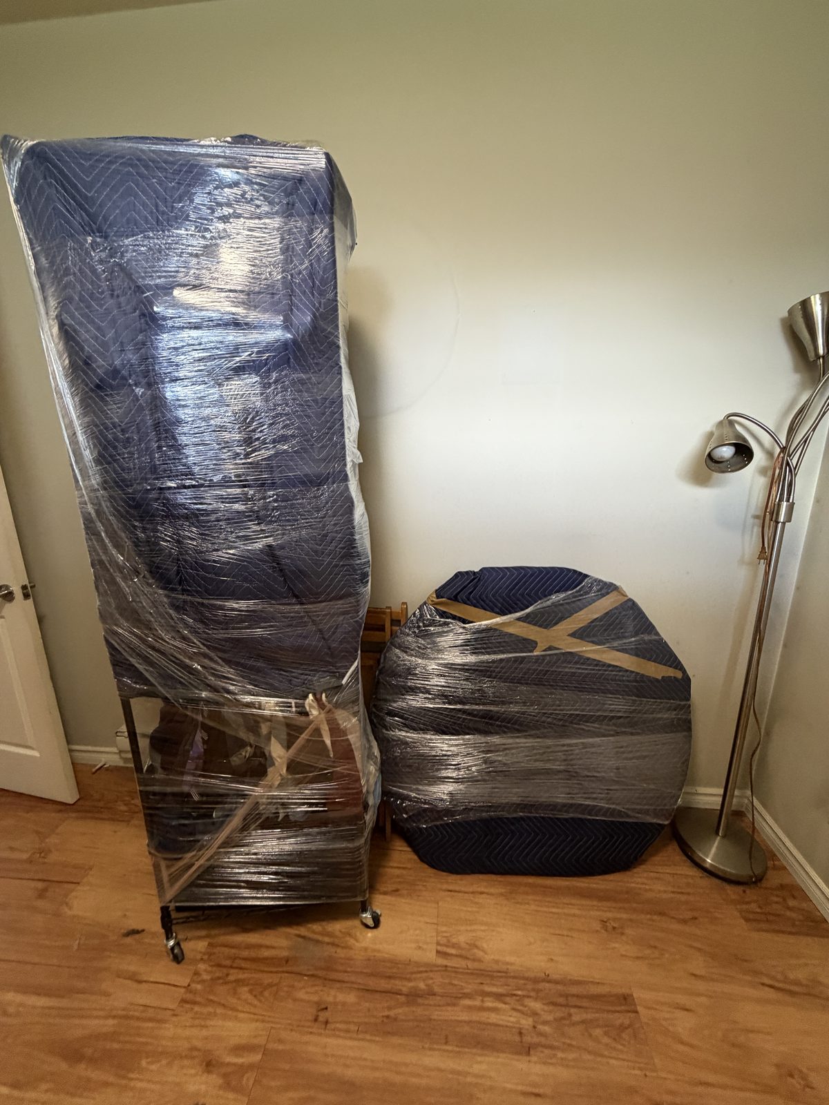 A dresser shrink-wrapped and protected in plastic, ready for the move